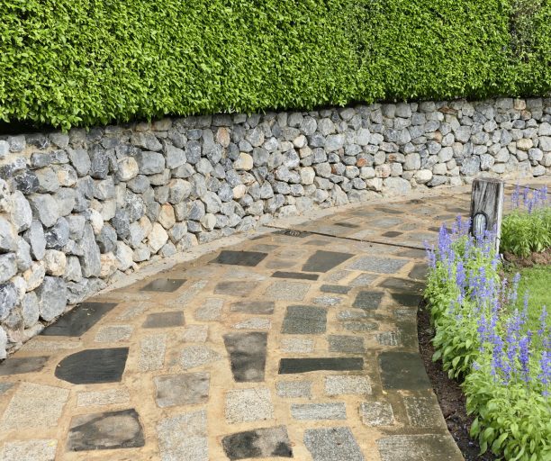 Concrete cement walkway in the garden lawn